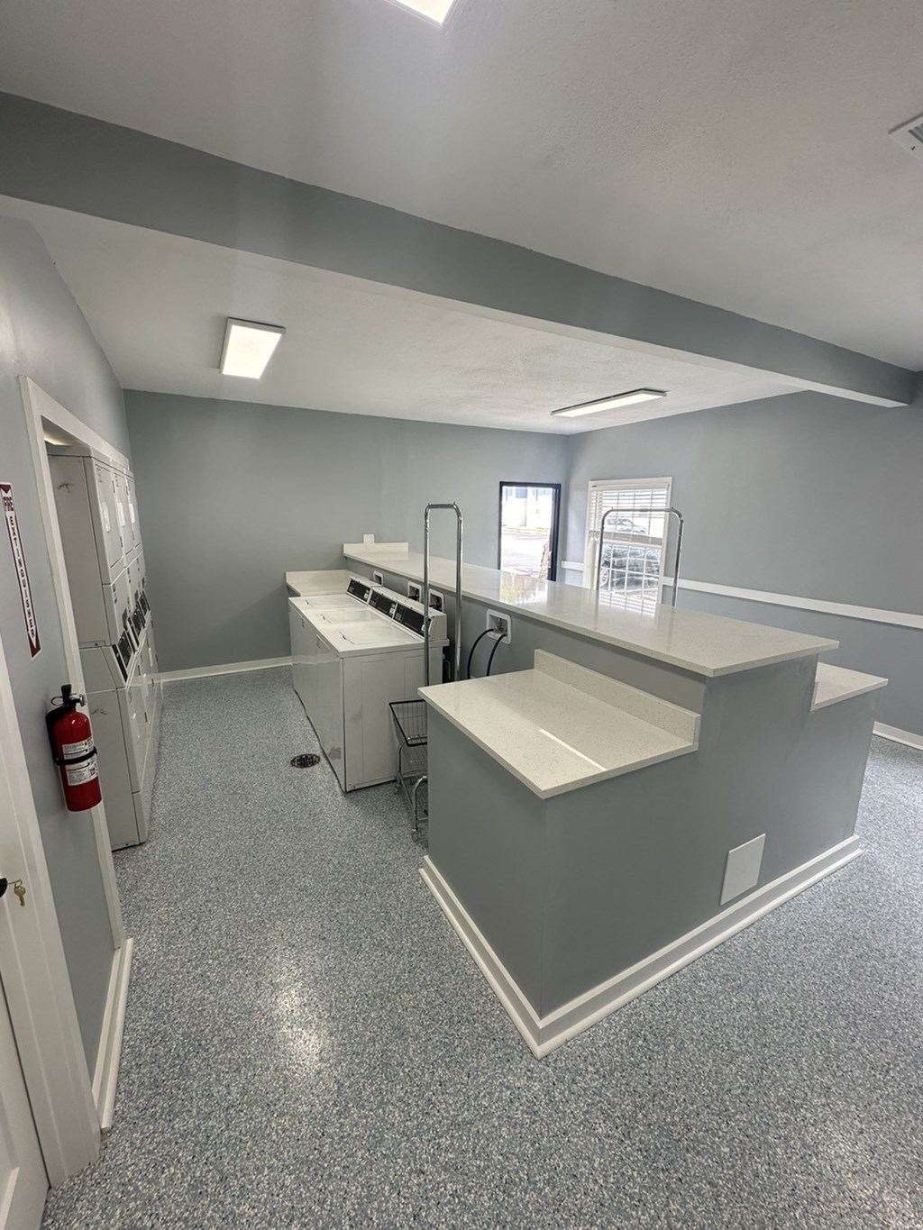 an empty room with a counter top and appliances in a building